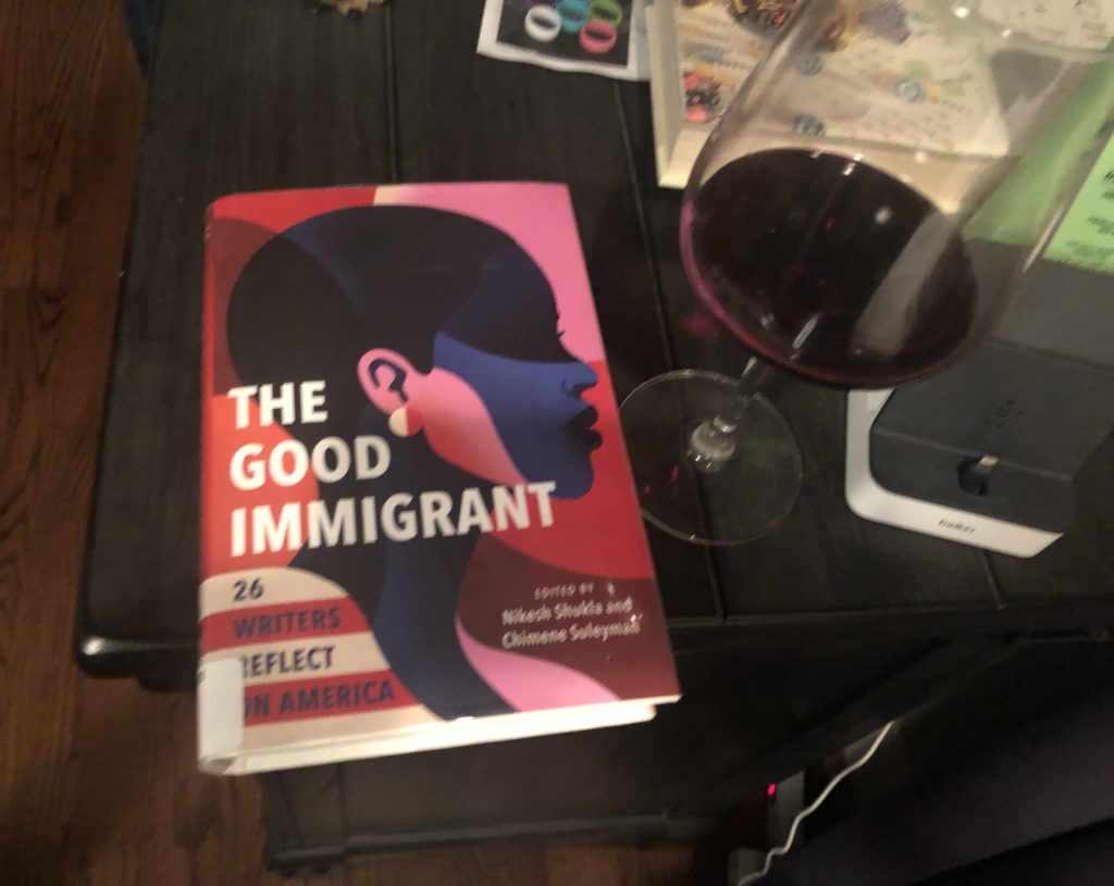 The Good Immigrant book with red wine